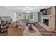 Inviting living area featuring a fireplace with white mantel and a comfortable gray sectional sofa at 8980 Country Club Dr, Douglasville, GA 30134