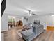 Inviting living room featuring a comfortable gray sectional sofa, ceiling fan, and hardwood flooring at 8980 Country Club Dr, Douglasville, GA 30134