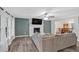 Open-concept living room featuring a fireplace, lots of natural light, and modern finishes at 8980 Country Club Dr, Douglasville, GA 30134