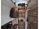 Walk-in closet with custom shelving and storage for clothing and accessories at 8980 Country Club Dr, Douglasville, GA 30134