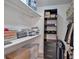 Walk-in closet with custom shelving and storage for clothing and accessories at 8980 Country Club Dr, Douglasville, GA 30134