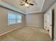 Main bedroom featuring tray ceiling, carpet, and neutral paint at 250 Whisperwood Nw Ln, Marietta, GA 30064