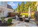 Backyard stone patio with cozy seating area and green landscaping at 2949 Gateland Sq, Marietta, GA 30062