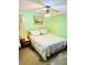 Cozy bedroom features a queen bed, a ceiling fan, and light green walls at 3112 Laura Ln, Lithia Springs, GA 30122