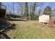 Backyard with grass, landscaping, retaining wall, shed and mature trees at 3461 Valley View Dr, Marietta, GA 30068