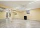 Spacious basement with a tiled floor, neutral paint, a mini fridge, and access to the exterior at 3461 Valley View Dr, Marietta, GA 30068