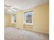 Bedroom featuring neutral carpet, neutral paint, ceiling fan, and windows with built-in storage at 3461 Valley View Dr, Marietta, GA 30068