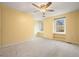 Bedroom featuring neutral carpet, neutral paint, ceiling fan, and built-in storage beneath the windows at 3461 Valley View Dr, Marietta, GA 30068