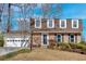 Charming brick home featuring a manicured lawn, attached garage and classic architectural details at 3461 Valley View Dr, Marietta, GA 30068