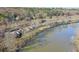 Aerial view of townhouses near a calm river, featuring brick exteriors and lush trees in a peaceful community at 3994 Columns Dr, Marietta, GA 30067