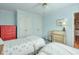 Comfortable bedroom with twin beds, a red dresser, and plenty of natural light at 3994 Columns Dr, Marietta, GA 30067