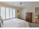 Cozy bedroom featuring a neutral color palette, plantation shutters, and classic furnishings at 3994 Columns Dr, Marietta, GA 30067