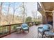 Outdoor deck with wicker furniture overlooking a scenic lake and wooded landscape at 3994 Columns Dr, Marietta, GA 30067