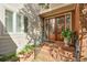 Charming front entrance with a beautiful wooden door, brick steps, and landscaped greenery creating an inviting curb appeal at 3994 Columns Dr, Marietta, GA 30067