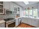 Charming kitchen featuring stainless steel appliances and abundant natural light at 3994 Columns Dr, Marietta, GA 30067