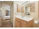 Bathroom featuring a single sink vanity, a mirror, and an entrance to a bedroom at 795 Hammond Dr # 709, Atlanta, GA 30328