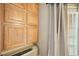 Bedroom with storage featuring wooden cabinets, curtains, and a window at 795 Hammond Dr # 709, Atlanta, GA 30328