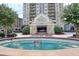 Up close view of the Park Towers entrance featuring a fountain and lush landscaping in a circular driveway at 795 Hammond Dr # 709, Atlanta, GA 30328