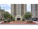 Beautiful exterior view of Park Towers, a luxury high-rise featuring a circular driveway and manicured landscaping at 795 Hammond Dr # 709, Atlanta, GA 30328