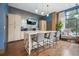 Modern kitchen island featuring gray chairs, stainless steel appliances, and stylish pendant lighting at 795 Hammond Dr # 709, Atlanta, GA 30328