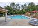 Inviting swimming pool surrounded by lounge chairs, umbrellas, and lush landscaping for relaxation and enjoyment at 795 Hammond Dr # 709, Atlanta, GA 30328