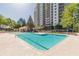 Outdoor swimming pool surrounded by trees, and a view of the high-rise building at 795 Hammond Dr # 709, Atlanta, GA 30328