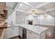Wet bar featuring granite countertops, wine refrigerator, and stylish brick wall at 8900 River Trace Dr, Johns Creek, GA 30097