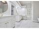 Bright bathroom featuring marble floors, double vanity, and a makeup vanity at 8900 River Trace Dr, Johns Creek, GA 30097