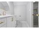 Modern bathroom featuring marble shower, gold fixtures, white vanity and tile floors at 8900 River Trace Dr, Johns Creek, GA 30097