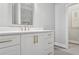 Bathroom featuring white cabinets, modern gold handles and faucets, and stone countertops at 8900 River Trace Dr, Johns Creek, GA 30097
