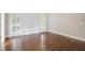 Empty bedroom featuring beautiful hard wood floors, light colored walls, and many windows at 8900 River Trace Dr, Johns Creek, GA 30097