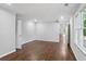 Spacious bedroom featuring hardwood floors and large windows to the backyard at 8900 River Trace Dr, Johns Creek, GA 30097