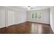 Neutral bedroom boasts hardwood floors, a ceiling fan, and double door closet at 8900 River Trace Dr, Johns Creek, GA 30097