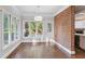 Cozy breakfast nook with hardwood floors, bright windows, and brick accent wall at 8900 River Trace Dr, Johns Creek, GA 30097