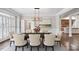 Elegant dining room featuring hardwood floors, wainscoting, and modern chandelier at 8900 River Trace Dr, Johns Creek, GA 30097