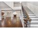 Grand foyer featuring a staircase with ornate iron railings and hardwood floors throughout at 8900 River Trace Dr, Johns Creek, GA 30097