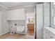 Laundry room with extra cabinets, sink, folding counter, and view into kitchen at 8900 River Trace Dr, Johns Creek, GA 30097