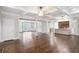 Open-concept living space with hardwood floors, connecting the living room, dining area, and kitchen at 8900 River Trace Dr, Johns Creek, GA 30097