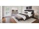 Comfortable main bedroom features a padded headboard, natural light, and neutral colors at 8900 River Trace Dr, Johns Creek, GA 30097
