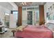 Inviting bedroom featuring large windows with city views and a private balcony at 44 Peachtree Ne Pl # 1225, Atlanta, GA 30309