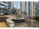 Outdoor fire pit area with seating, offering a relaxing communal space among modern high-rise buildings at 44 Peachtree Ne Pl # 1225, Atlanta, GA 30309