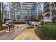 Outdoor grilling area with a stainless steel grill and seating, set against a backdrop of high-rise buildings at 44 Peachtree Ne Pl # 1225, Atlanta, GA 30309