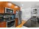 Modern kitchen featuring stainless steel appliances, hardwood floors, and black granite countertops at 44 Peachtree Ne Pl # 1225, Atlanta, GA 30309