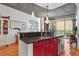 A kitchen featuring black countertops, dark-red cabinets, modern lighting, and a scenic view from the window at 44 Peachtree Ne Pl # 1225, Atlanta, GA 30309