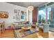 Stylish living room with hardwood floors, comfortable seating, and floor-to-ceiling windows showcasing city views at 44 Peachtree Ne Pl # 1225, Atlanta, GA 30309