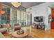 Living room featuring a large flat screen tv and balcony access with an outdoor dining set at 44 Peachtree Ne Pl # 1225, Atlanta, GA 30309