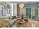 Sun-filled living room with hardwood floors, comfortable seating, and balcony access for seamless indoor/outdoor living at 44 Peachtree Ne Pl # 1225, Atlanta, GA 30309