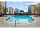 A sparkling outdoor pool surrounded by modern buildings and lounge chairs, perfect for relaxation and recreation at 44 Peachtree Ne Pl # 1225, Atlanta, GA 30309