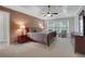 Cozy main bedroom featuring a brick accent wall, carpet, and a ceiling fan at 420 Glenridge Close Ct, Atlanta, GA 30328