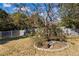 Spacious backyard featuring a flower bed with vibrant red roses and a wooden fence at 2316 Watson Fain Trl, Loganville, GA 30052